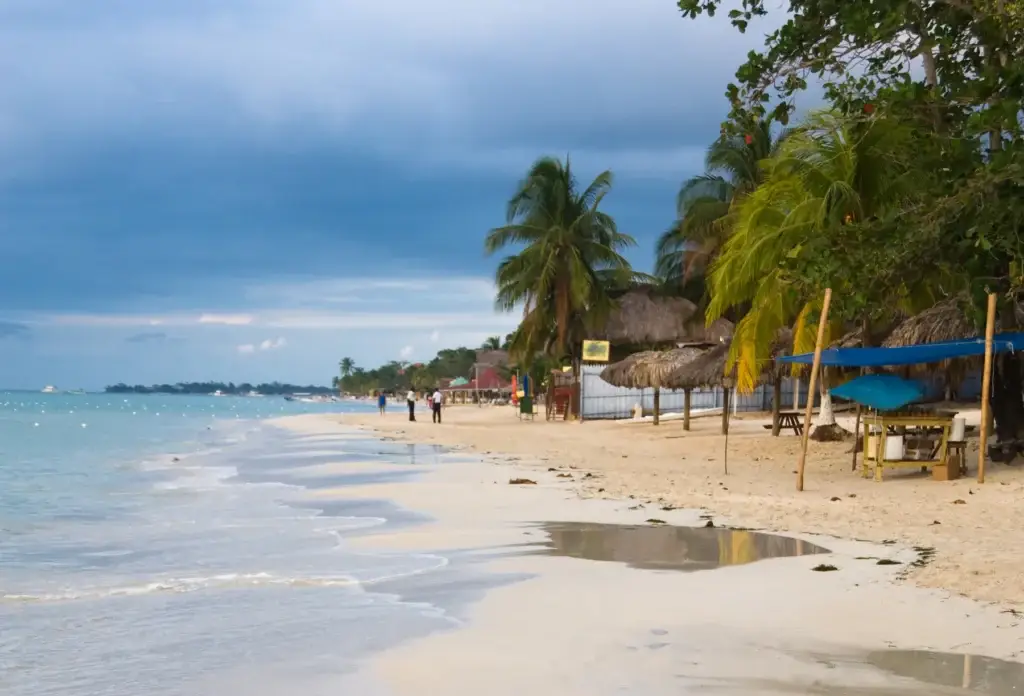 A Jamaican beach beneath storm clouds.