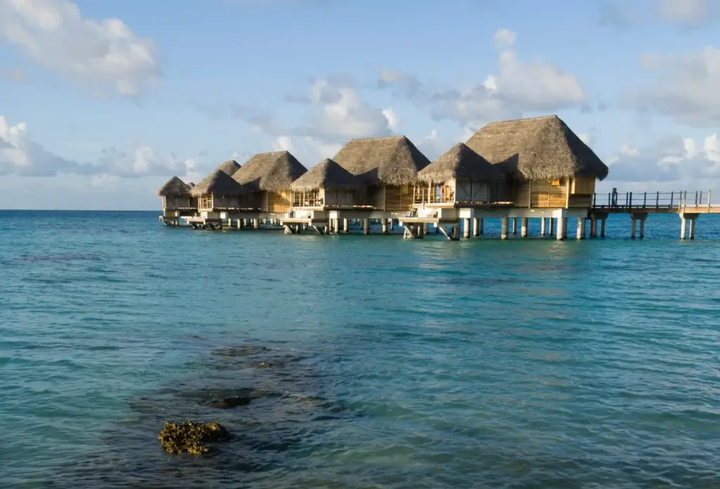 Overwater bungalows and shallow lagoon waters on Tikehau.